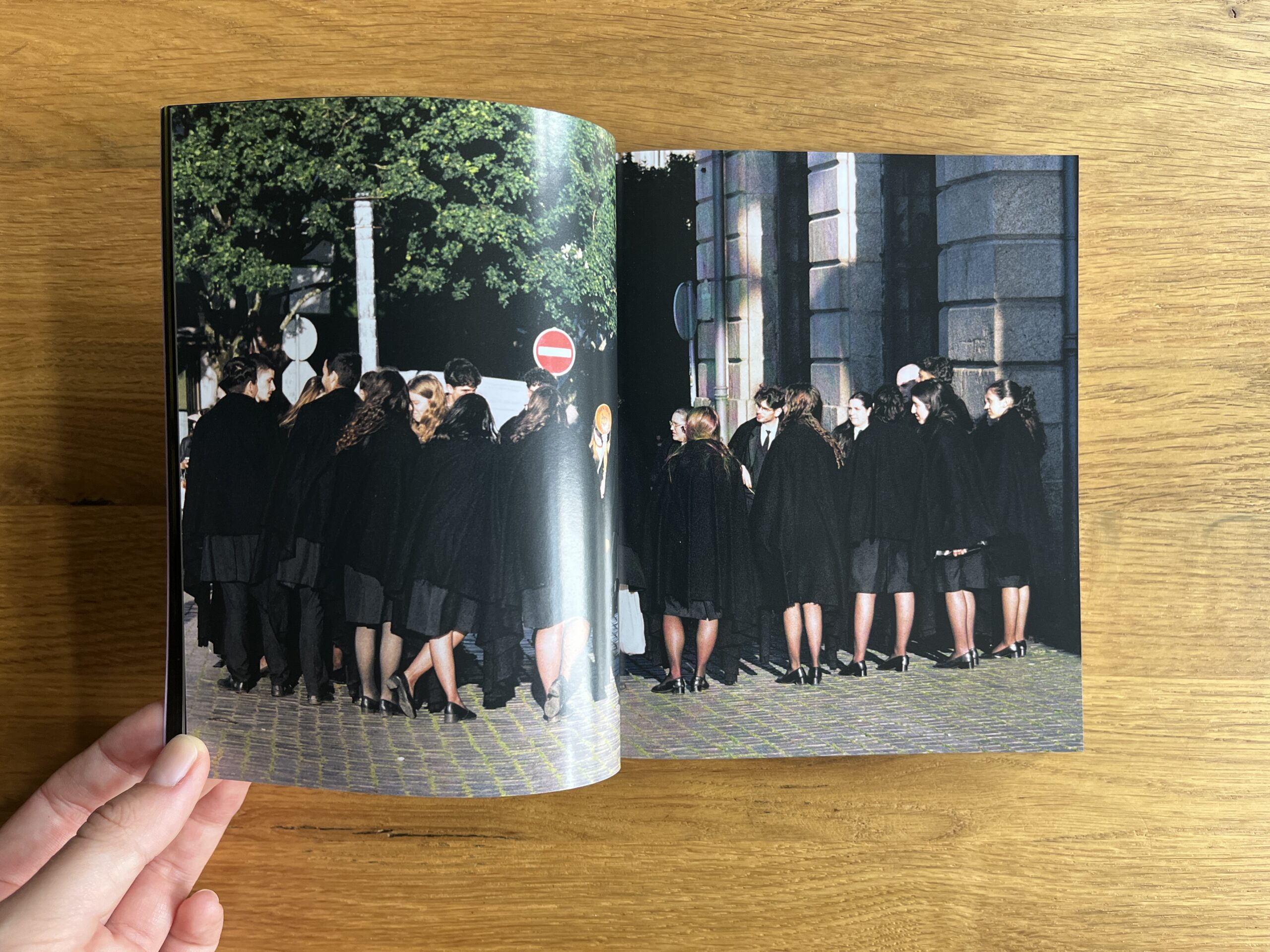 Open spread from Mixed showing a group of people in black academic robes gathered outside a stone building.
