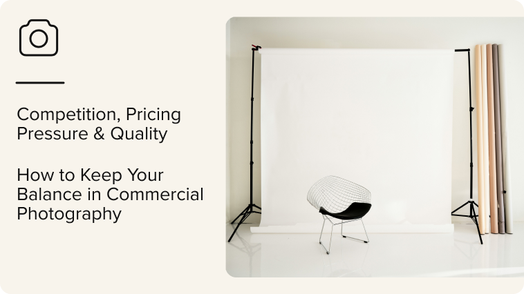 Minimalist photography studio with a white backdrop, chair, and rolled paper backgrounds.