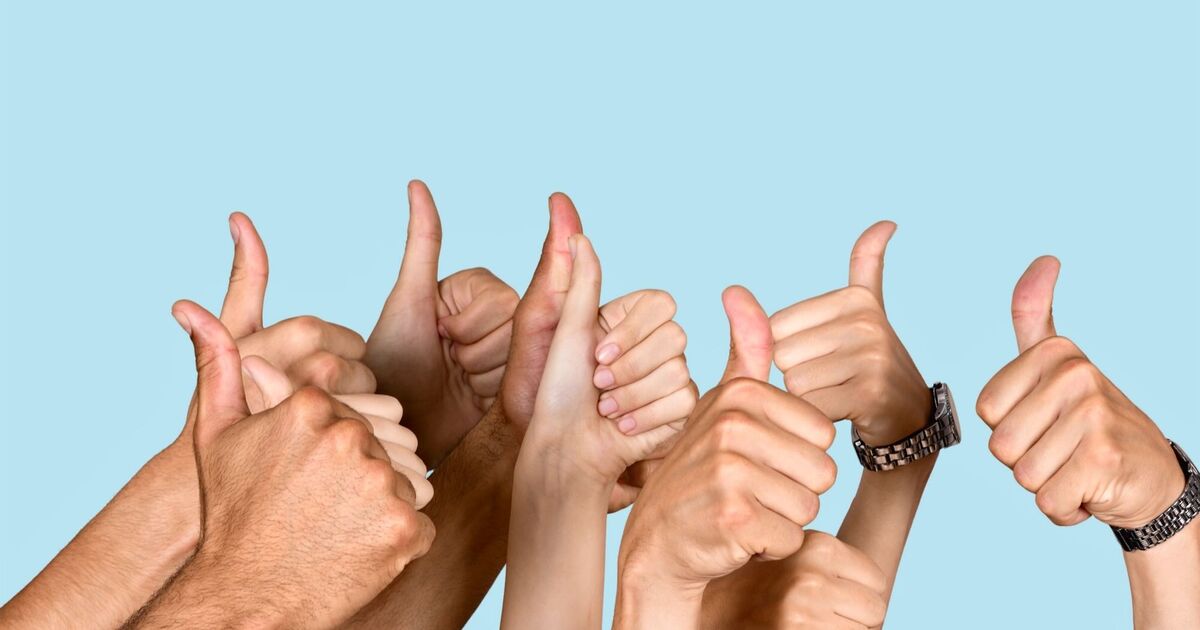 Several hands of different skin tones giving a thumbs-up gesture against a light blue background, symbolizing approval or positivity.