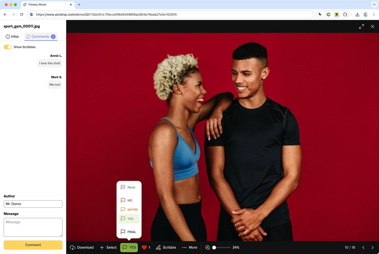 Two people stand smiling in front of a red background; the woman on the left wears a blue sports bra and has her arm on the mans shoulder, while the man on the right wears a black athletic shirt.